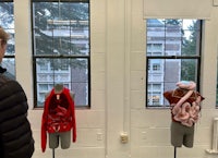 a man looking at mannequins in a room