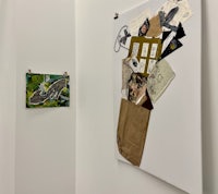 a room with several pieces of art hanging on the wall